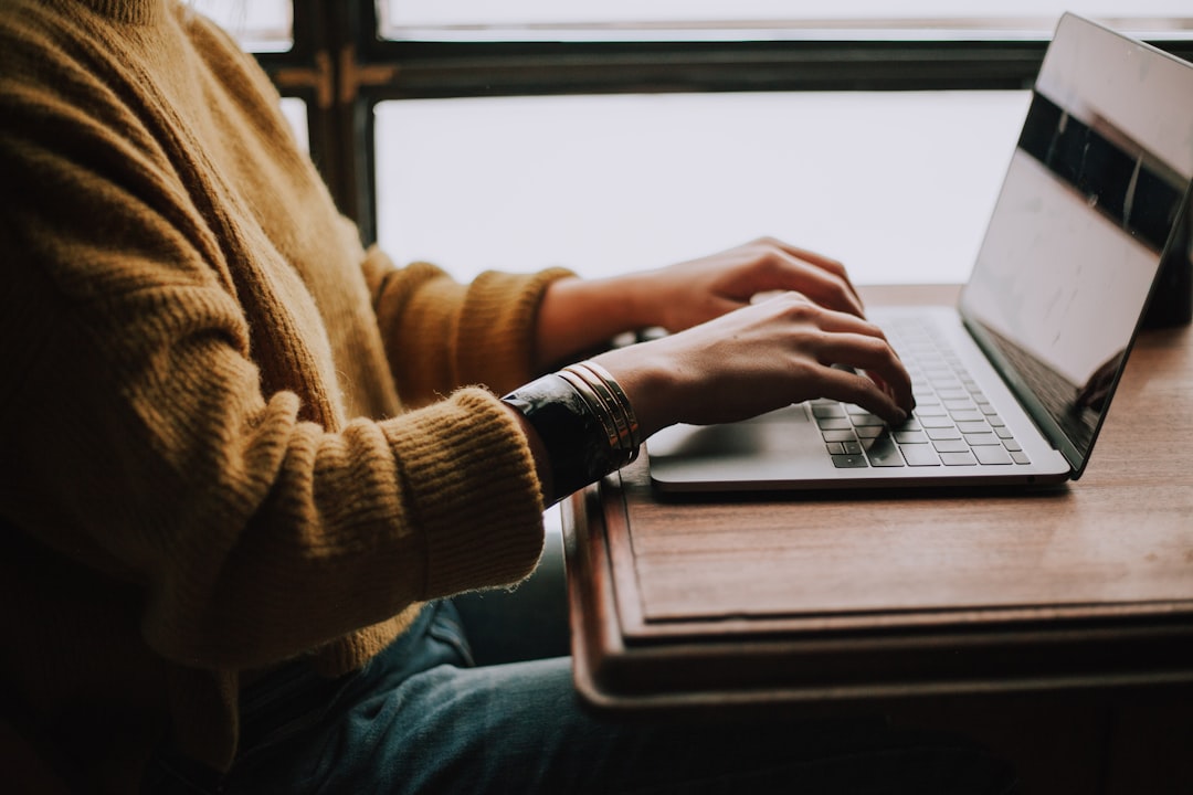 A person working on a laptop, symbolizing office task automation.